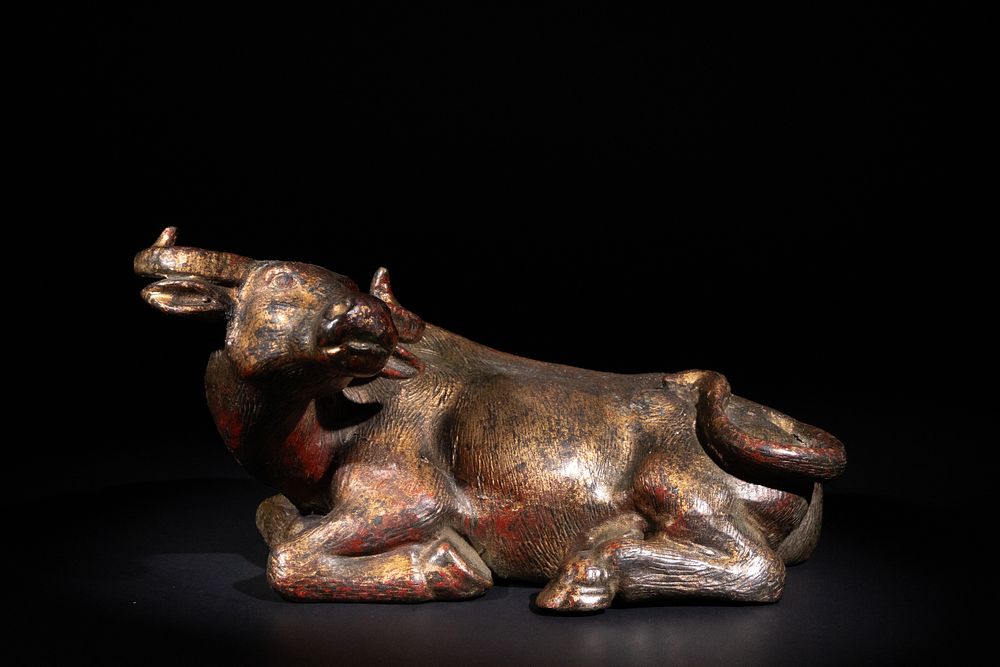 Lot 283: A Chinese Gilt Bronze Recumbent Buffalo.