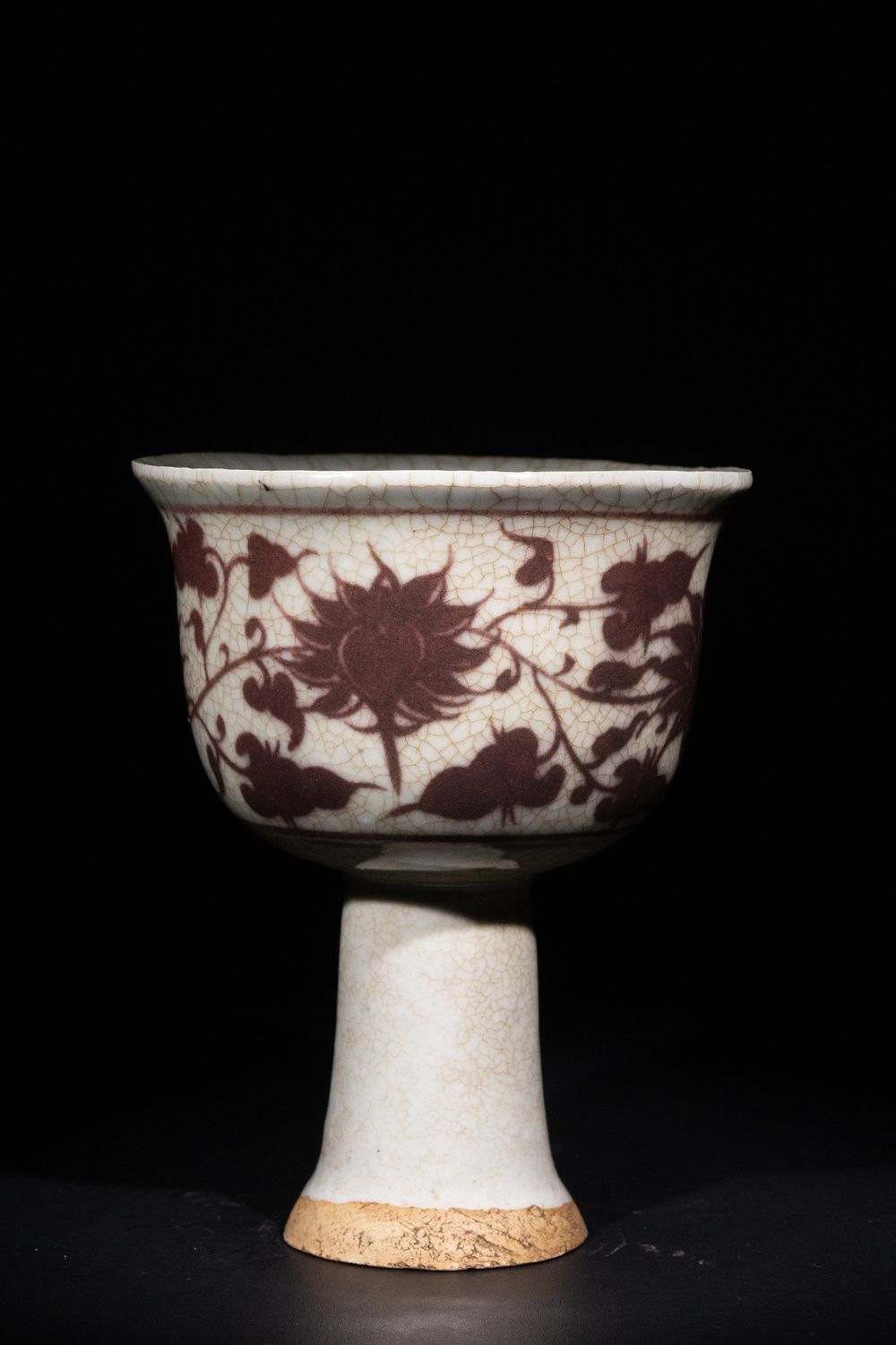 Lot 285: A Chinese Crackle-Glazed Stem Cup with Floral Motif.
