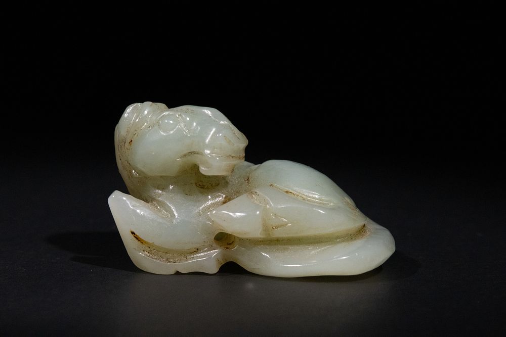 Lot 316: A Chinese Pale Green Jade Figure of a...