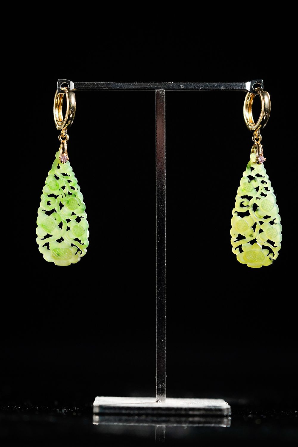 Lot 324: A Pair of Chinese Carved Green Jade Earrings.