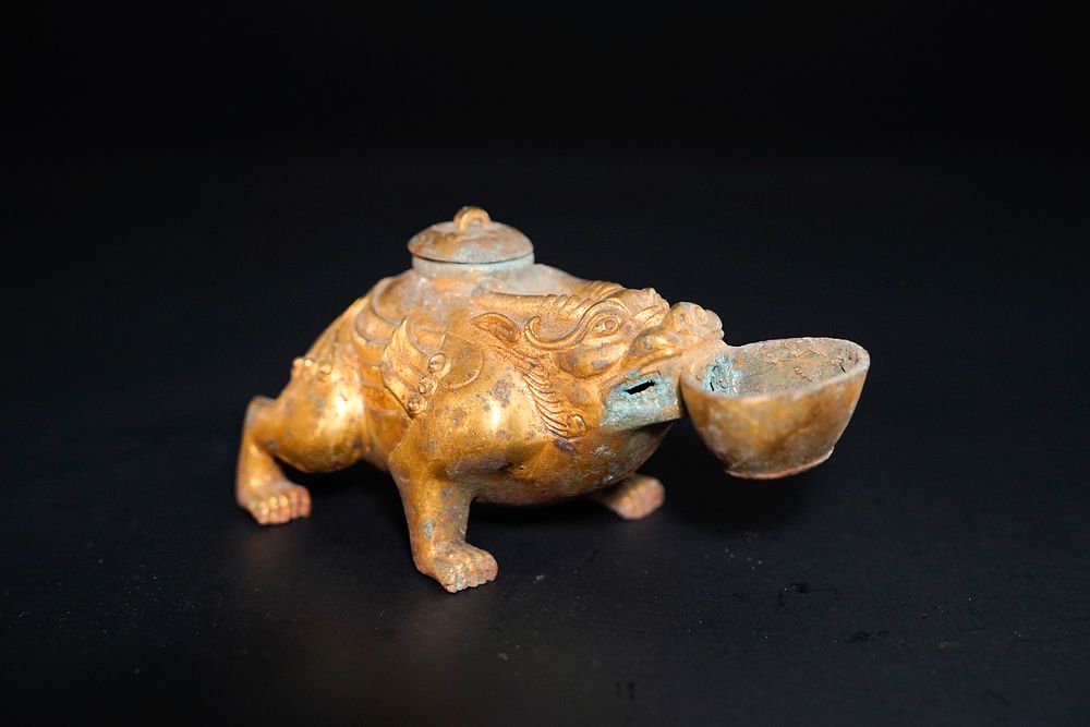 Lot 348: A Chinese Gilt-Bronze Mythical Beast Oil Lamp.