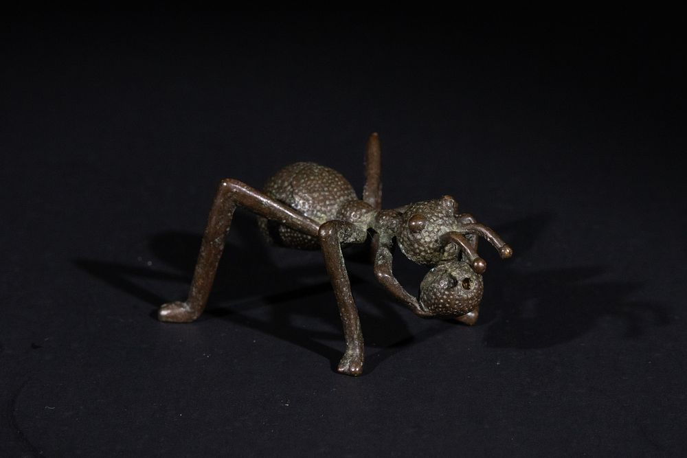 Lot 370: A Japanese Bronze Ant Okimono Carrying a Nut.