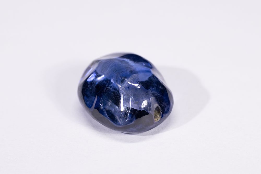 Lot 163: An Indian Polished Dark Blue Gemstone Bead, Possibly...