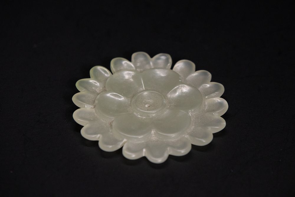 Lot 165: A Mughal Celadon Jade Lotus Bloom Button, 19-20th...