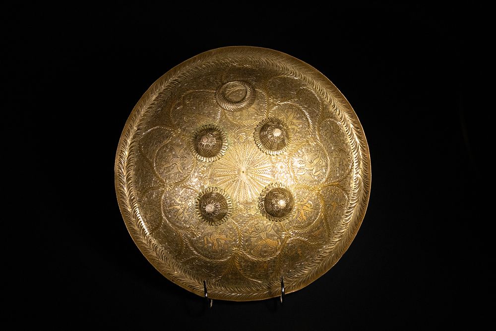Lot 174: An Indian Engraved Brass Shield, 19th Century.