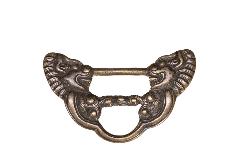 Lot 242: A Tibetan Copper Sutra Buckle, Qing Dynasty.