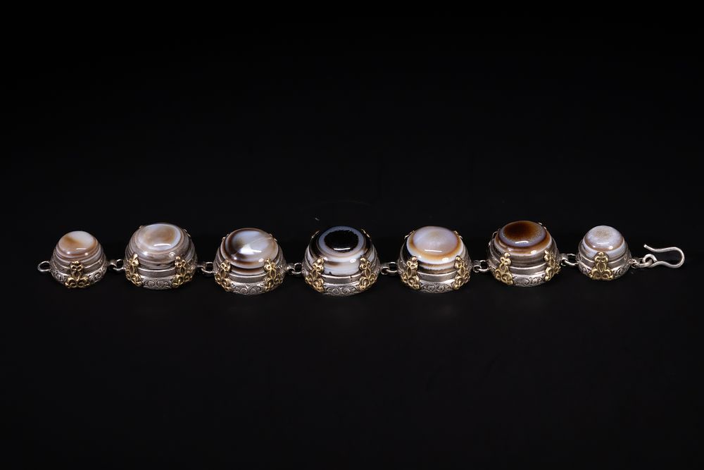 Lot 247: A Tibetan Silver Bracelet Set with Seven Banded...