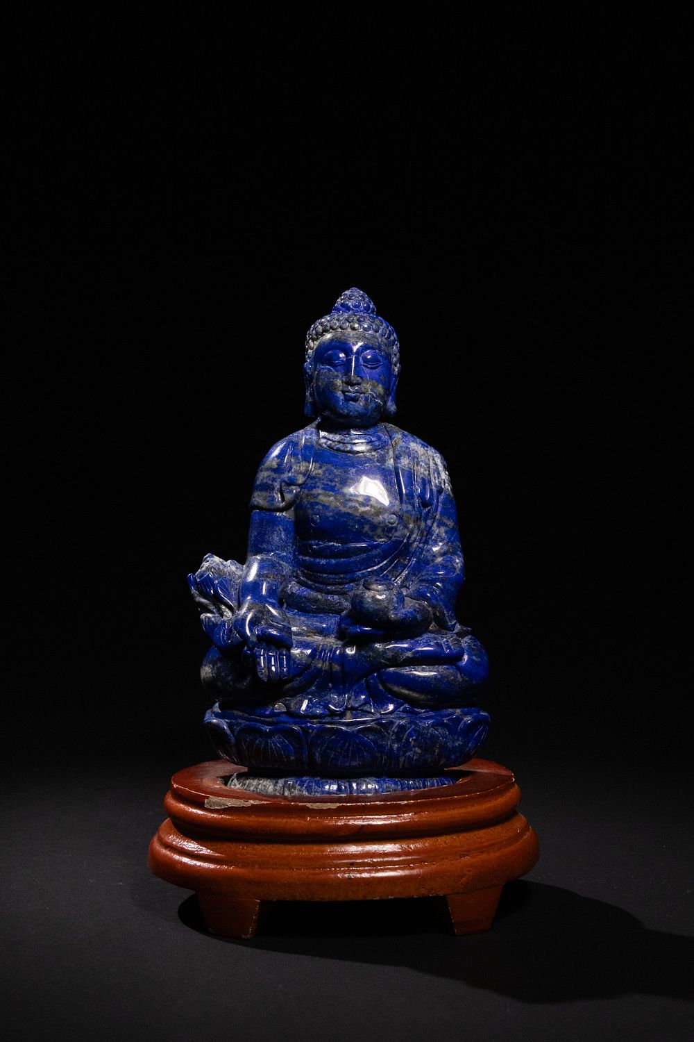Lot 259: A Tibetan Lapis Lazuli Figure of a Seated...