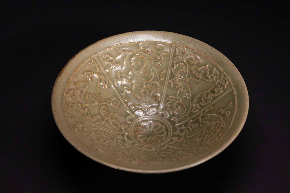 Lot 264: A Chinese Celadon-Glazed Carved Bowl.
