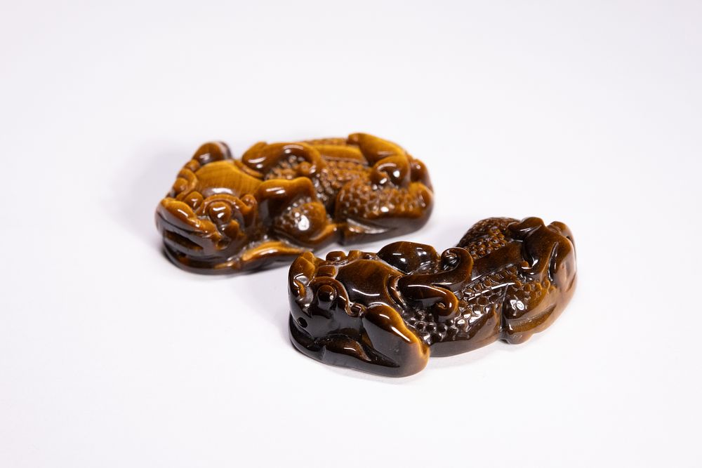 Lot 272: A Pair of Chinese Tiger's Eye Pixiu Beasts...