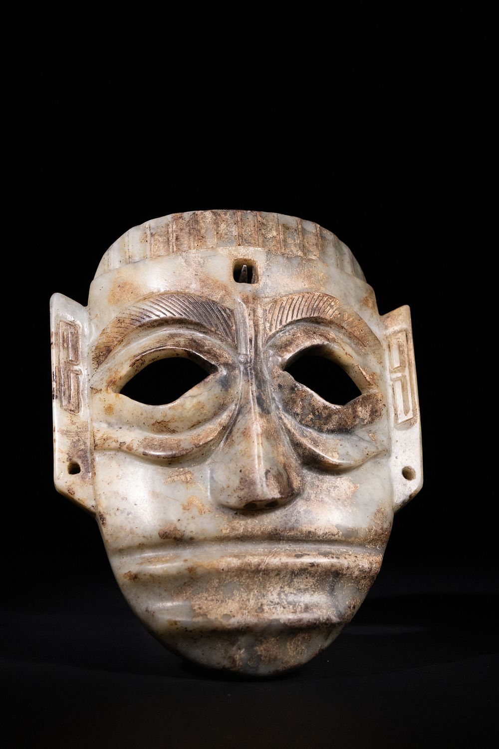 Lot 276: A Chinese Archaistic Jade Mask with Stylised Facial...