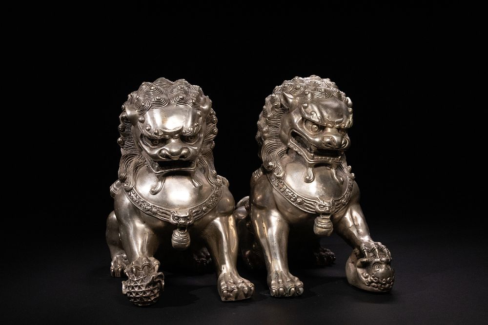Lot 338: A Pair of Chinese White Metal Guardian Lions...
