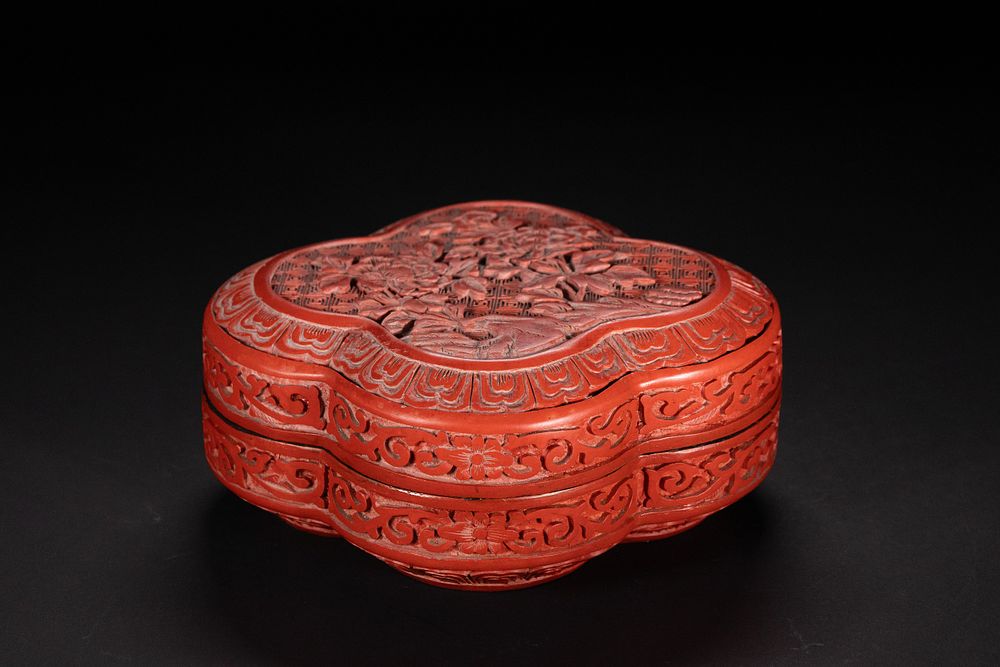 Lot 359: A Chinese Red Cinnabar Lacquer Quatrefoil Lidded Box.