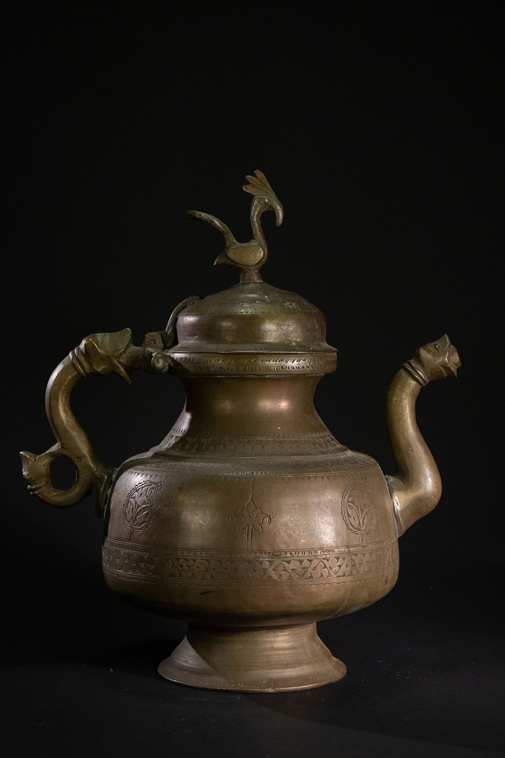 Lot 183: An Indian Brass Ritual Vessel with Bird Finial.