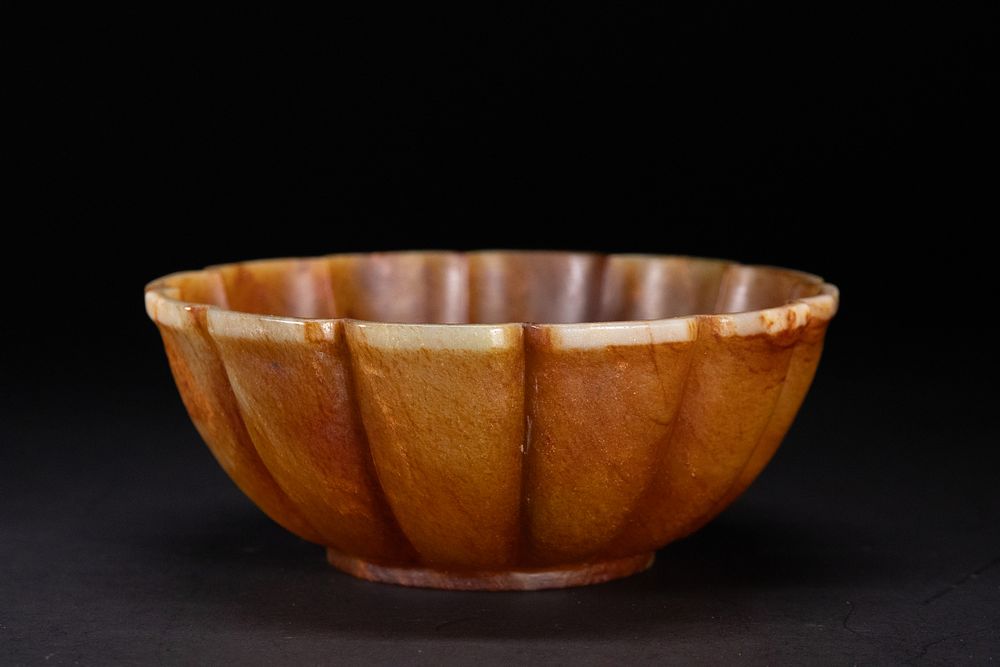 Lot 191: A Mughal Carved Russet Jade Lobed Bowl.