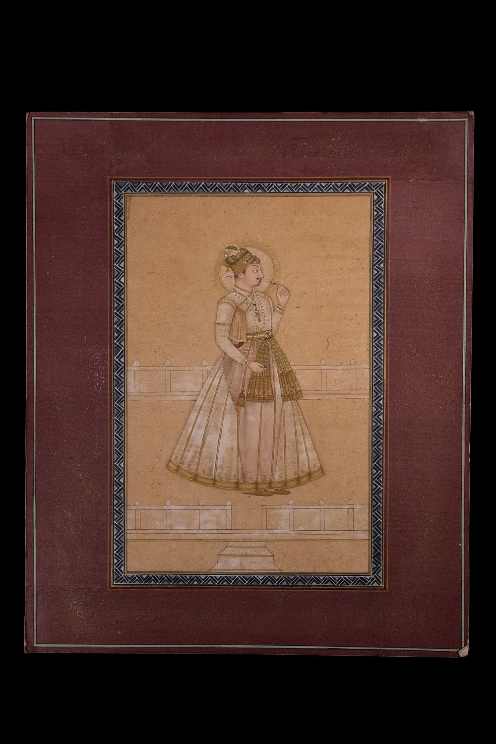 Lot 193: An Indian Miniature Depicting a Mughal Prince Holding...