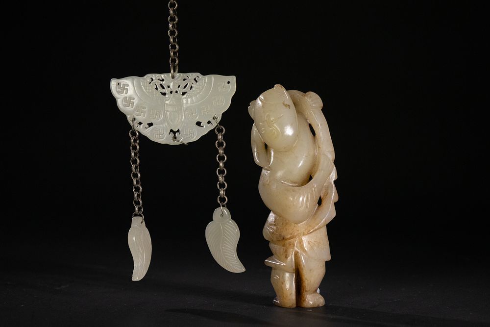 Lot 260: A Chinese Jade Boy Holding Lotus and Bat,...