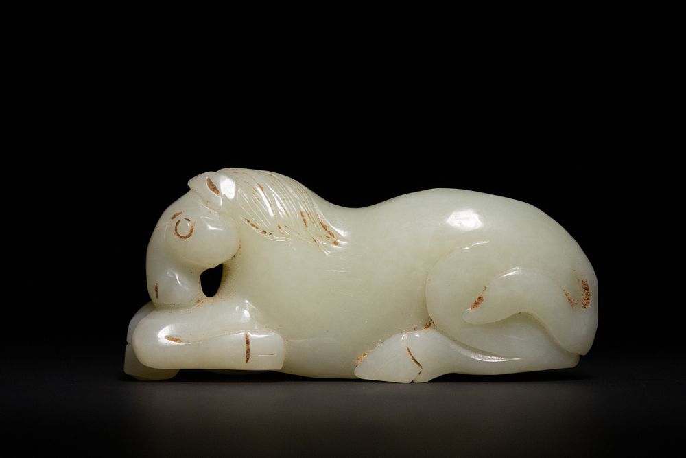 Lot 274: A Chinese Jade Carving of a Recumbent Horse.
