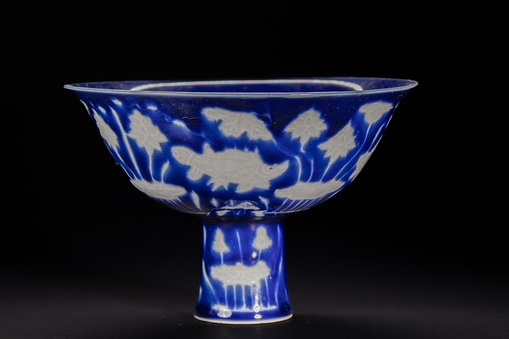 Lot 288: A Chinese Blue-Ground Stem Cup with White Carved...