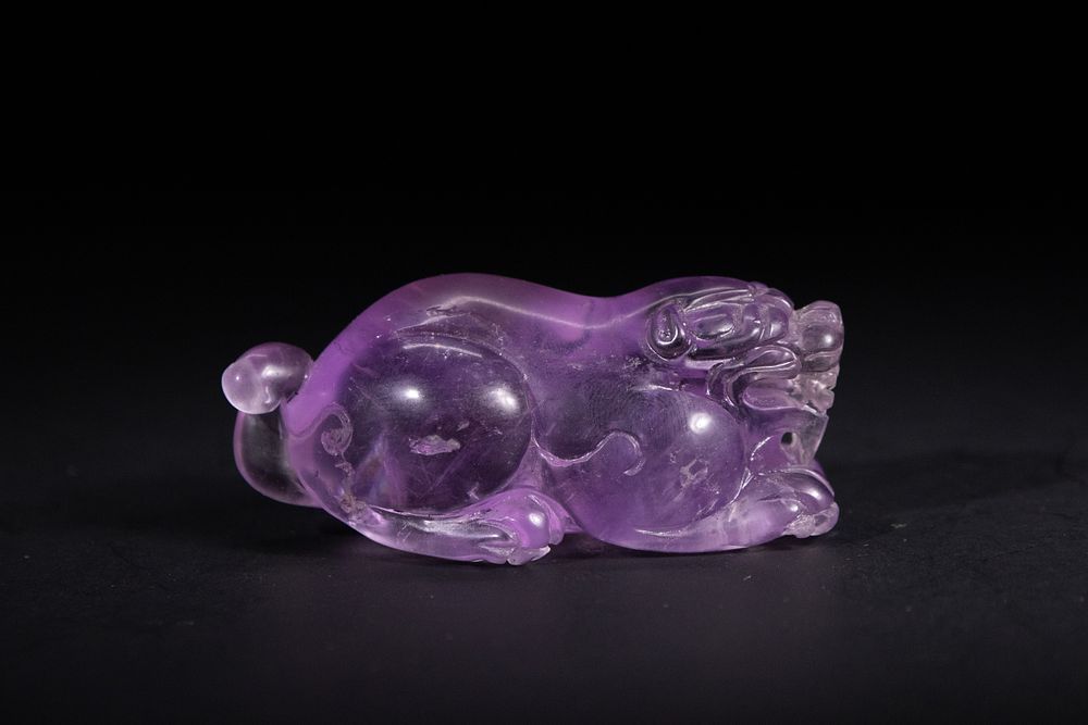 Lot 326: A Chinese Amethyst Carving of a Recumbent Pixiu.