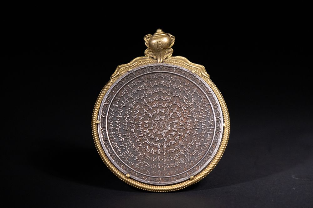 Lot 353: A Tibetan Buddhist Gilt Copper Amulet with Inscribed...