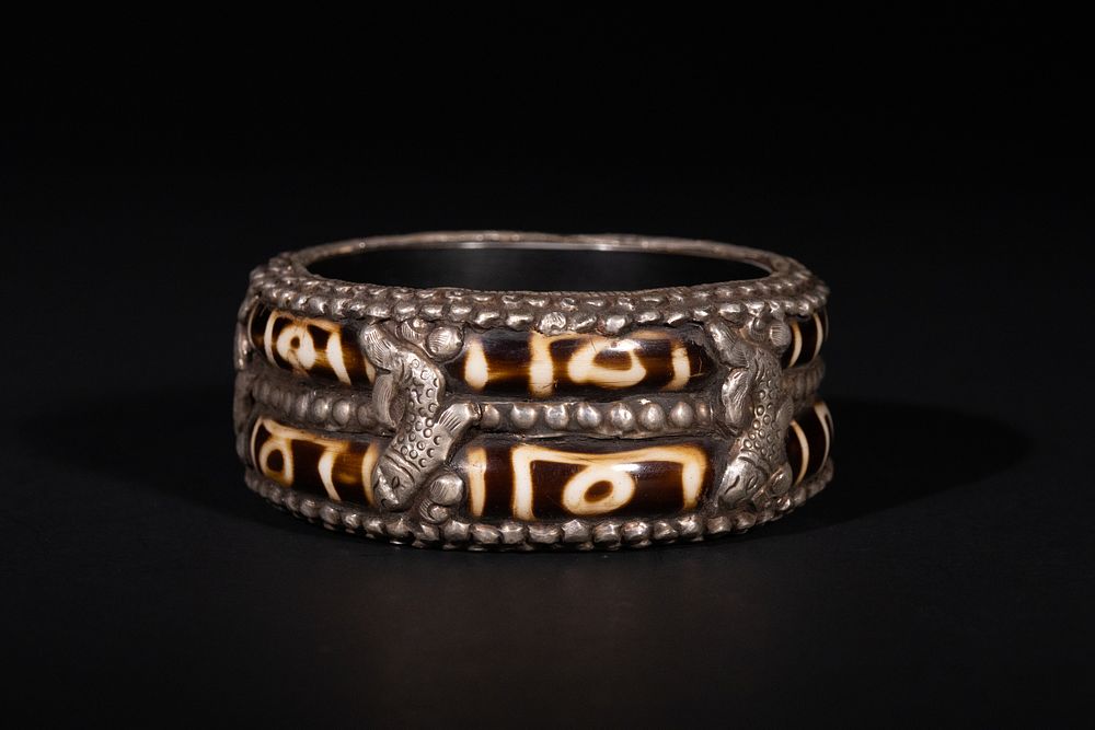 Lot 220: A Tibetan White Metal Bracelet Inset with Agate...
