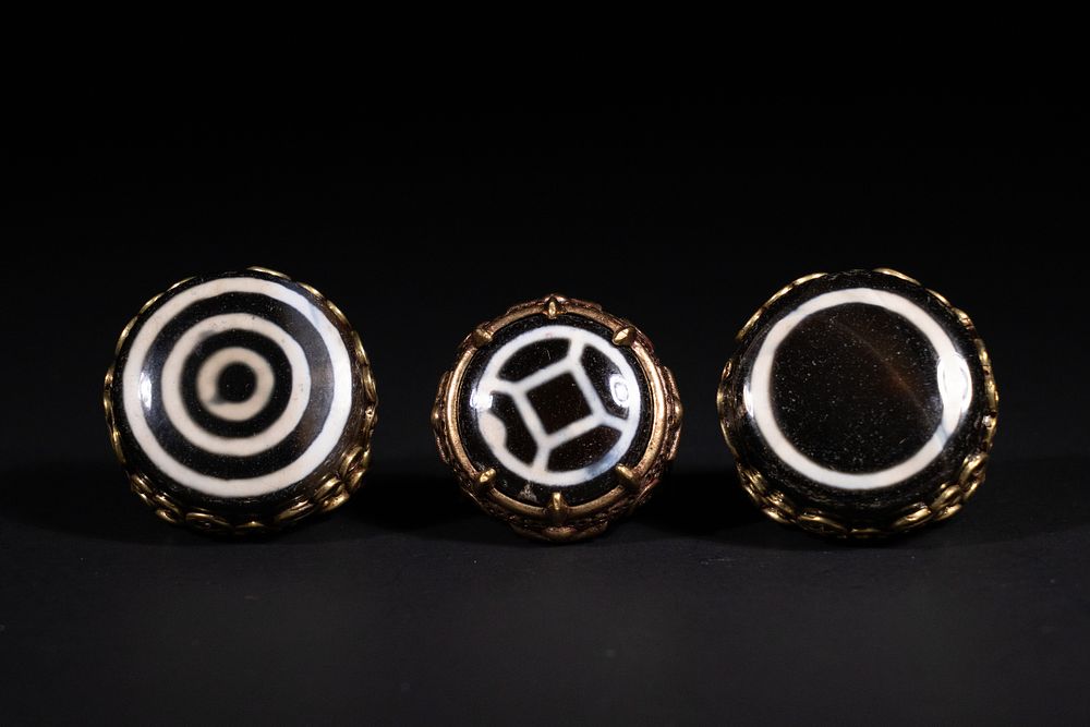 Lot 223: A Lot of Three Tibetan Dzi Bead Rings.