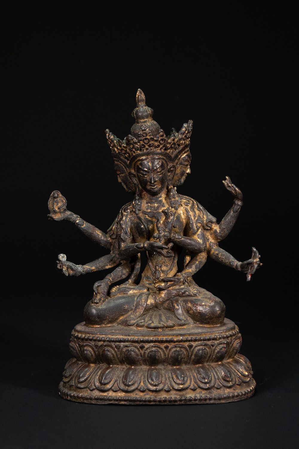 Lot 231: A Tibetan Gilt-Bronze Figure of a Multi-Armed Deity.