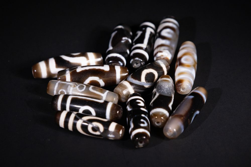 Lot 236: A Collection of Tibetan Dzi Beads with Etched...