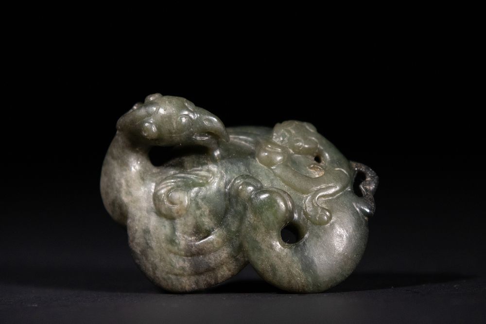 Lot 268: A Chinese Green Jade Carving of a Phoenix.