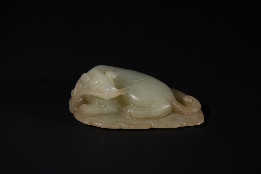 Lot 270: A Chinese Celadon Jade Carving of a Recumbent...