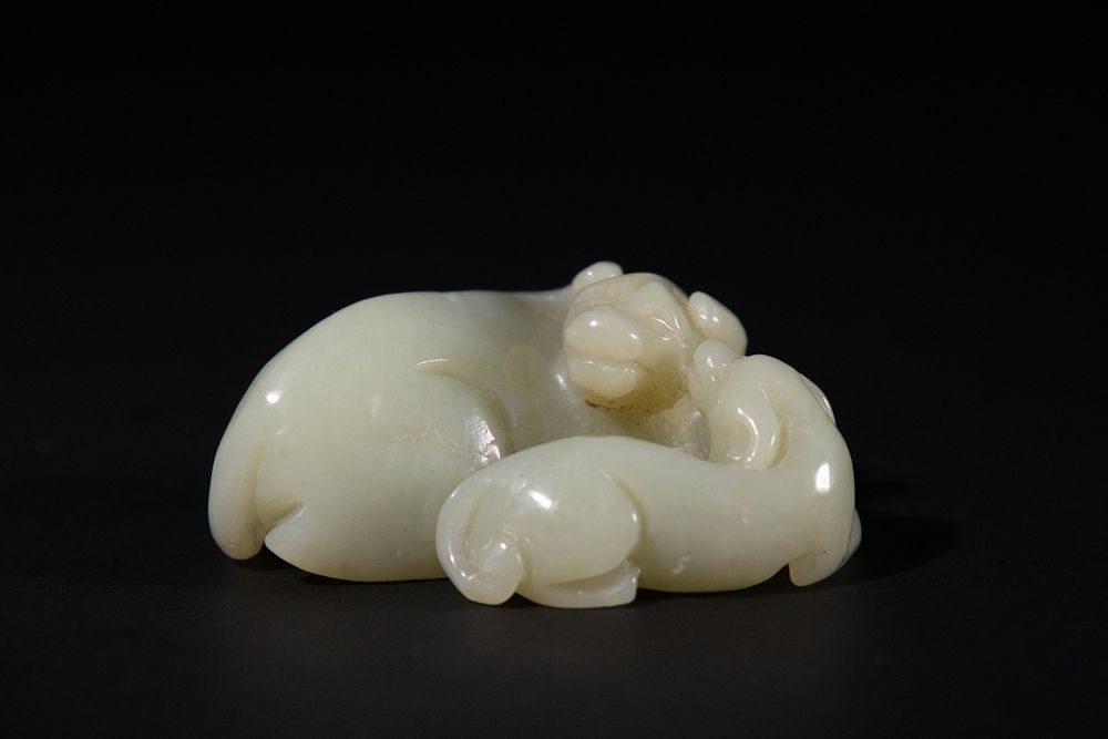 Lot 271: A Chinese White Jade Carving of Two Recumbent...