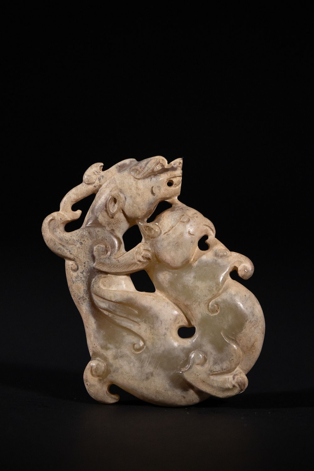 Lot 283: A Chinese Jade Carving of Confronting Mythical Beasts,...