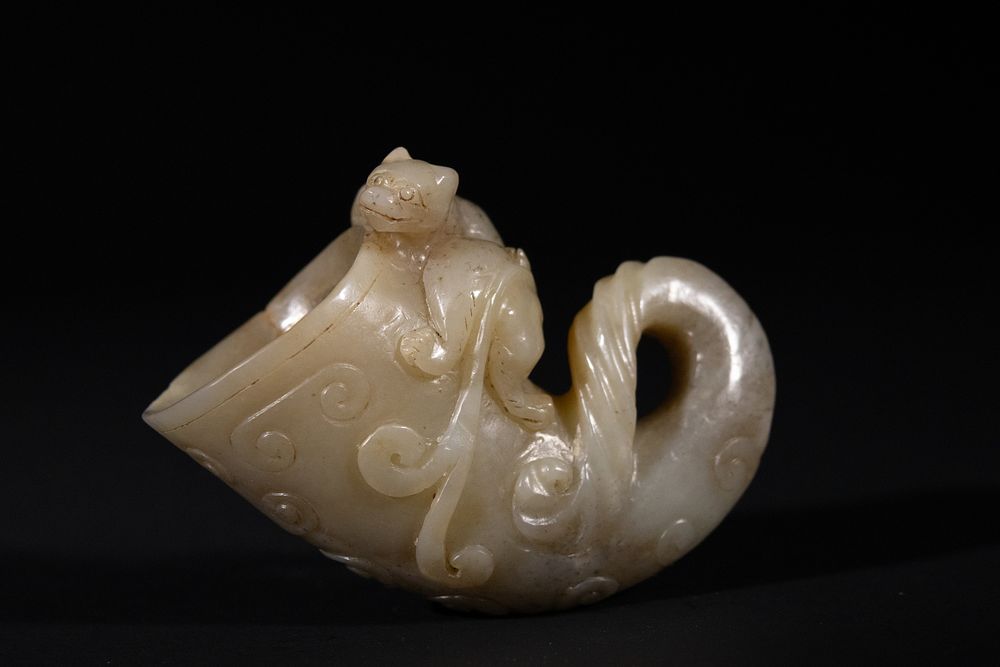Lot 284: A Chinese Jade Rhyton with Animal Carving, 19th...