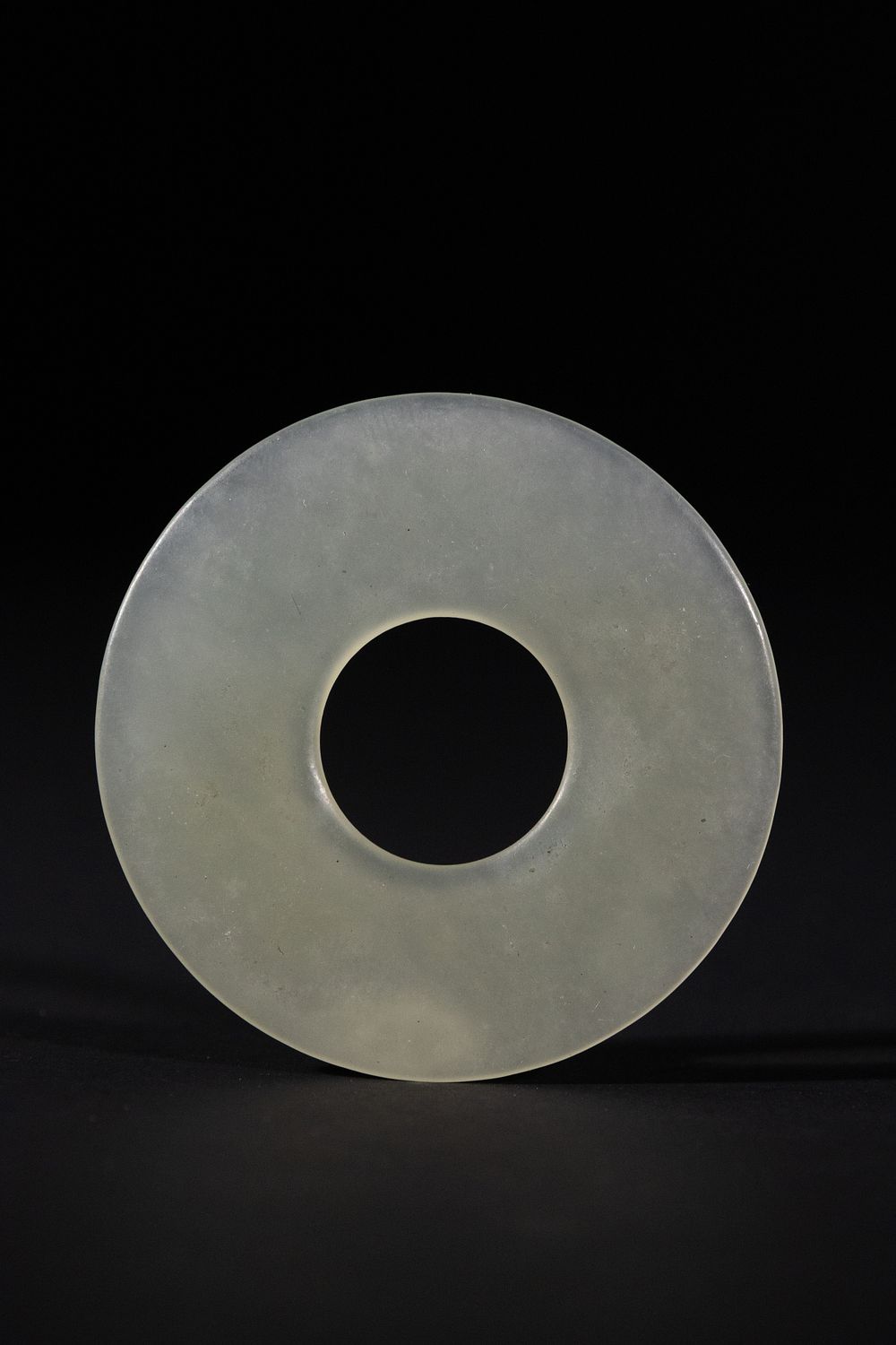 Lot 296: A Chinese White Jade Bi Disc.