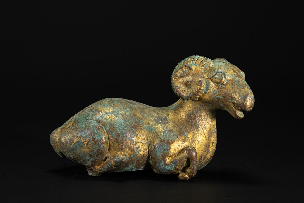 Lot 330: A Chinese Gilt-Bronze Figure of a Recumbent Ram.