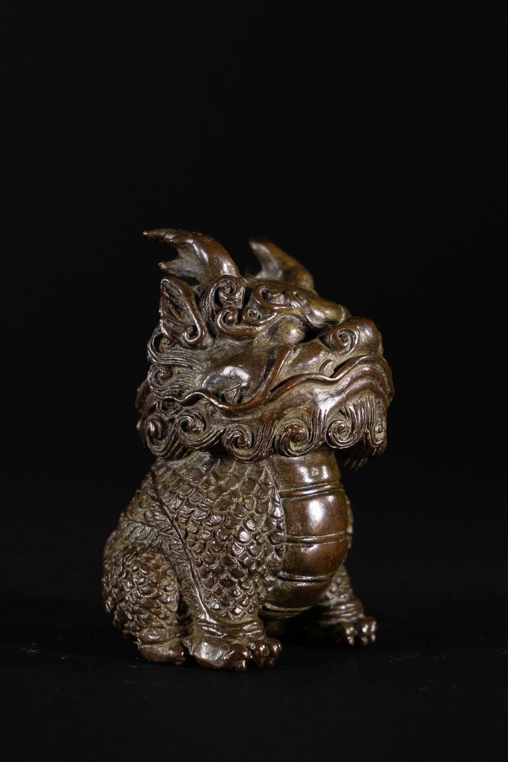 Lot 390: A Japanese Bronze Figure of a Seated Mythical...