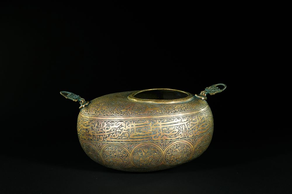 Lot 166: A Qajar Brass Kashkul with Figural and Calligraphic...