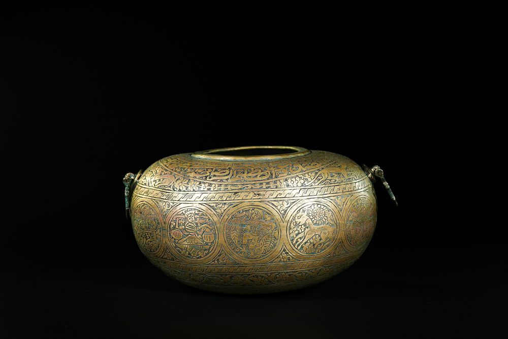 Lot 167: A Qajar Brass Engraved Kashkul with Figural and...