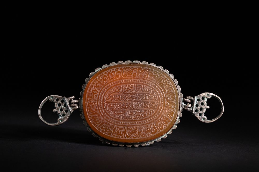 Lot 171: An Islamic Silver-Mounted Carnelian Calligraphic Plaque.