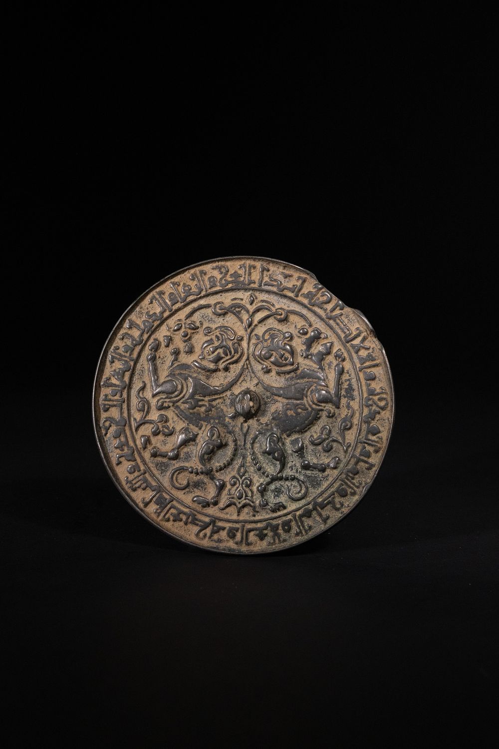 Lot 185: A Seljuk Bronze Mirror with Mythical Beasts, 12th–13th...