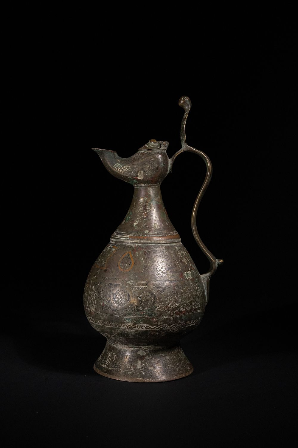 Lot 187: A Khorasan Copper-Inlaid Bronze Ewer with Figural Handle,...