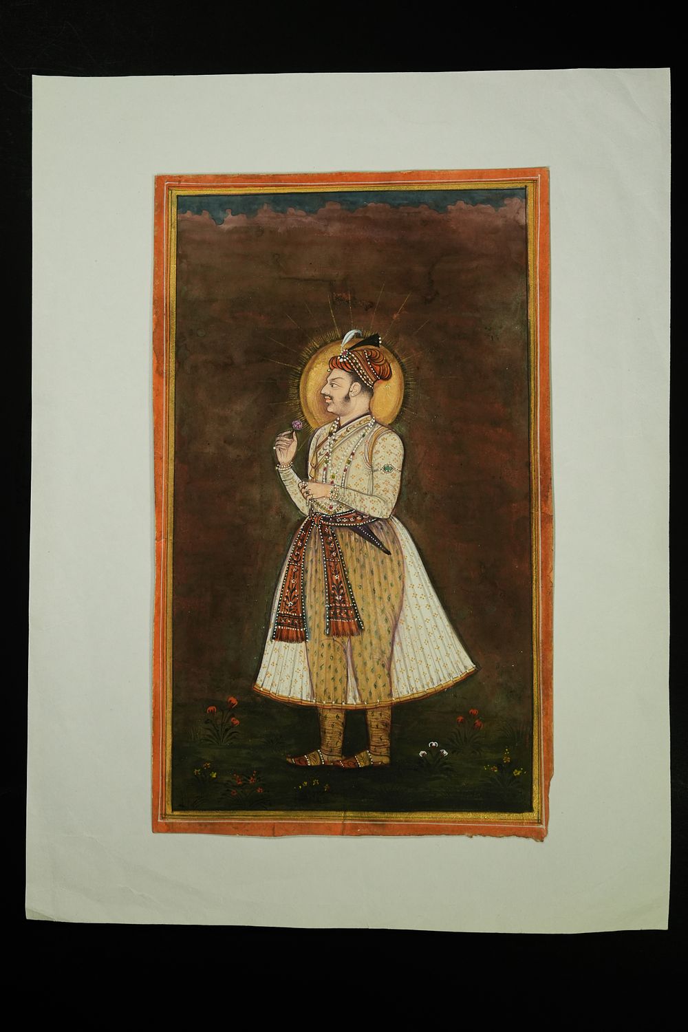 Lot 244: An Indian Mughal Portrait of a Nobleman Holding...