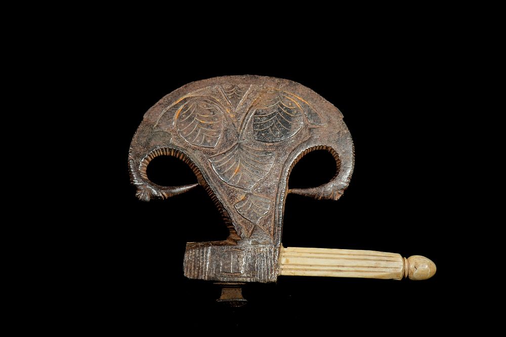 Lot 284: An Indian Iron and Bone Ceremonial Axe Head,...