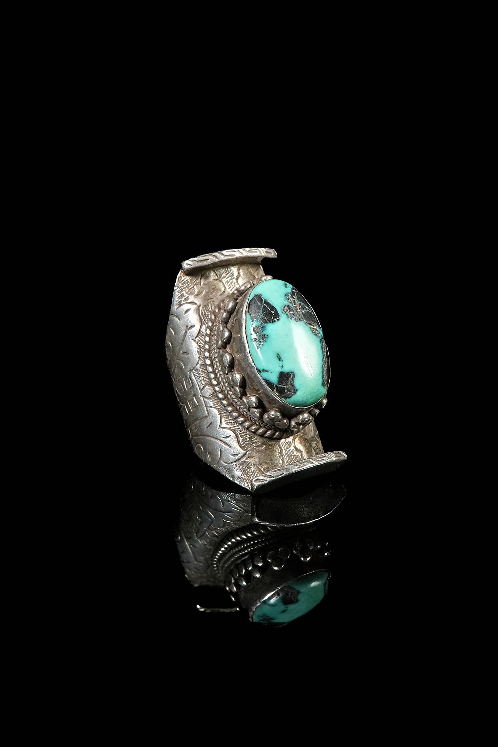 Lot 313: A Tibetan Silver Turquoise-Set Finger Guard, 19th Century.