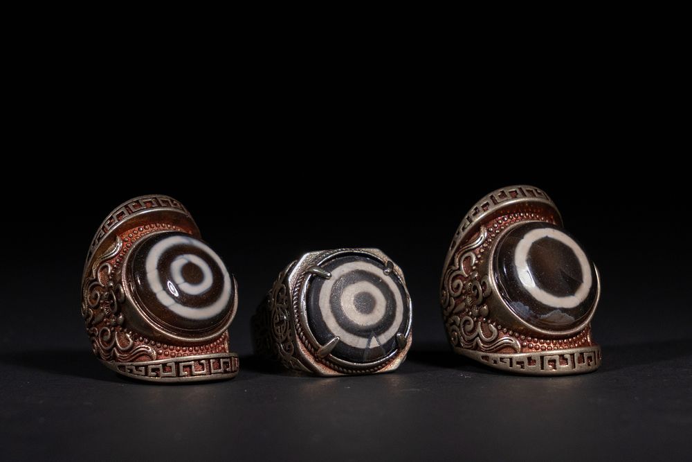 Lot 322: A Lot of Three Tibetan Dzi Bead Rings.