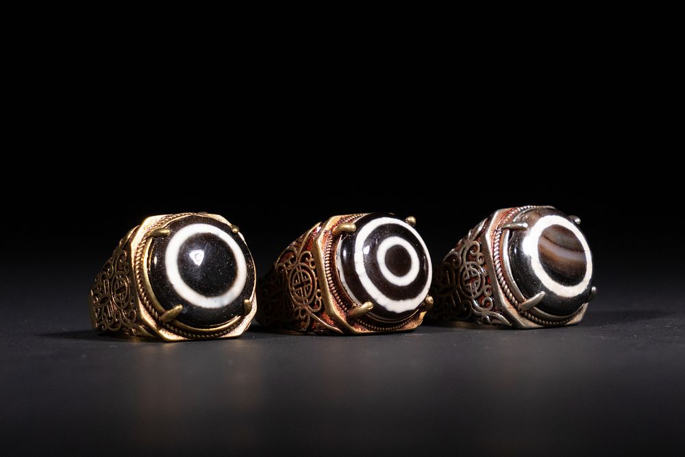 Lot 323: A Lot of Three Tibetan Dzi Bead Rings.