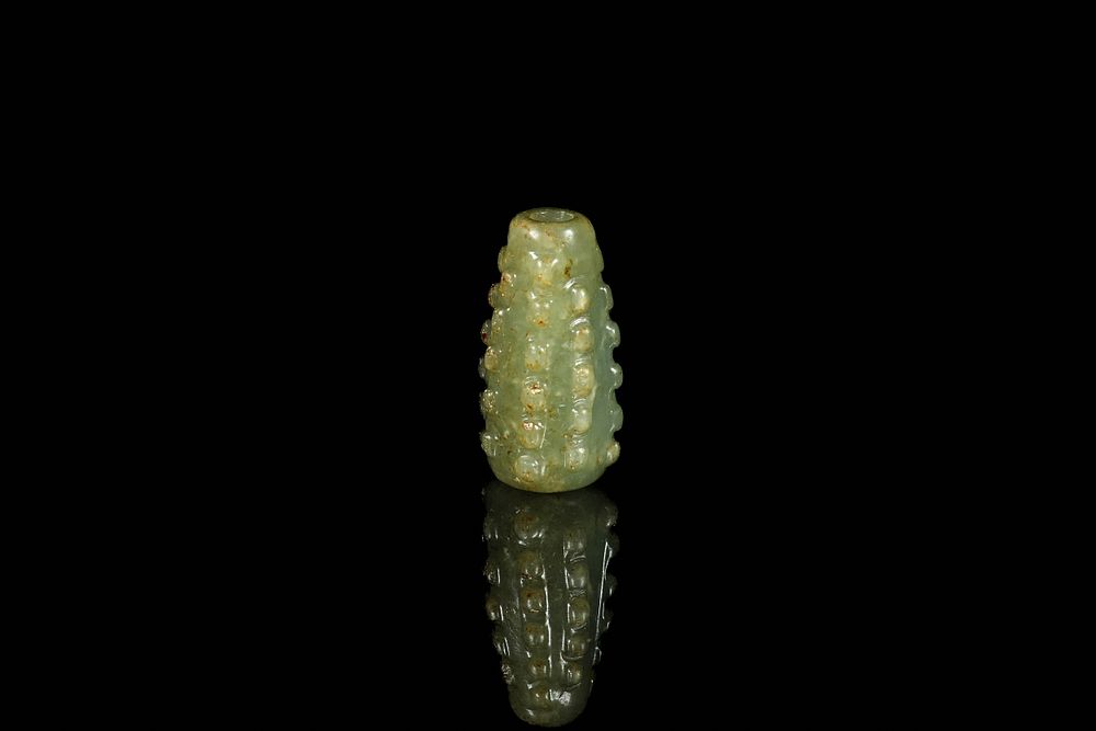 Lot 333: A Chinese Jade Beaded Cylindrical Pendant.