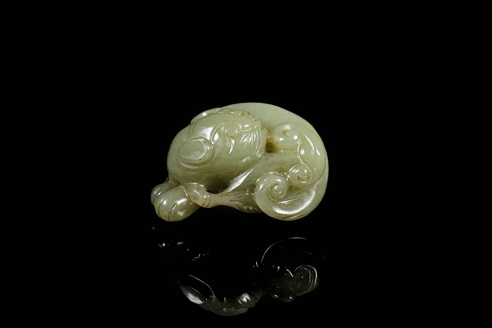 Lot 336: A Chinese Celadon Jade Carving of a Recumbent...