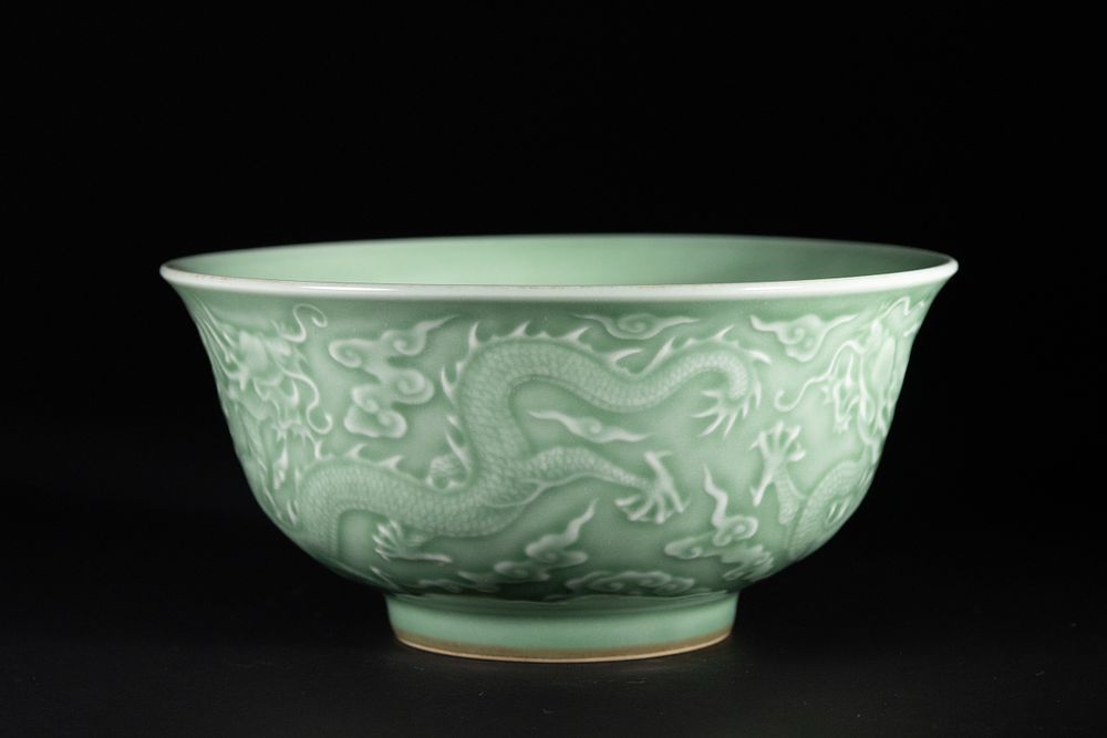 Lot 396: A Chinese Celadon-Glazed Porcelain Bowl with Dragon Motif.